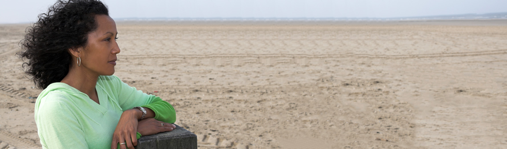 black-woman-pondering-at-the-beach